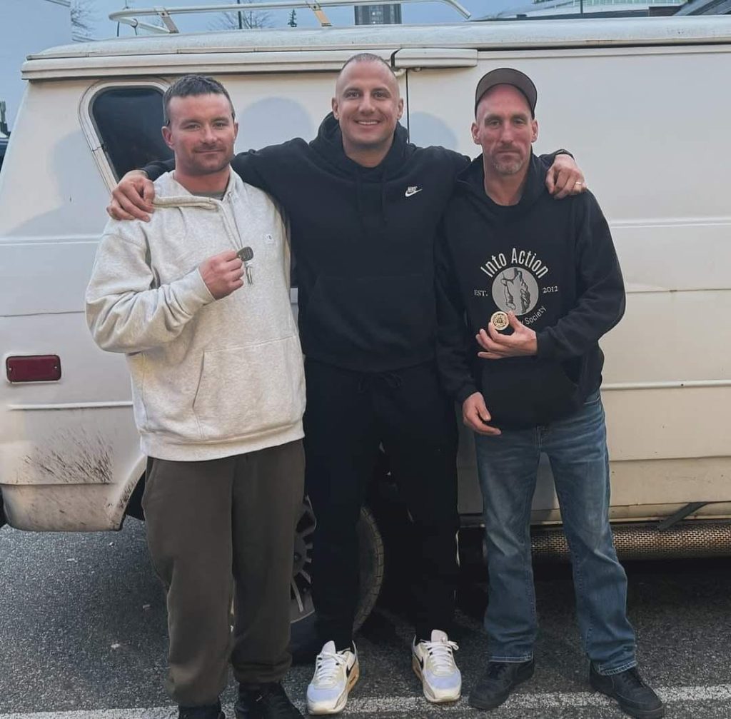 Into Action team in front of a van