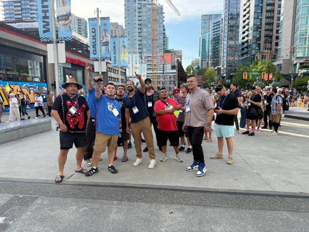 alumni members pose for group picture holding their certificates