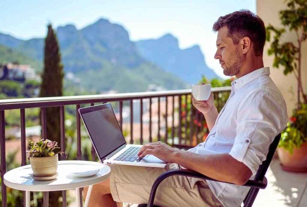 A Man In Alcohol Recovery Sitting With His Laptop and Coffee Outside