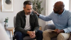 IOP Group Topics hero image showing men working together in group therapy.