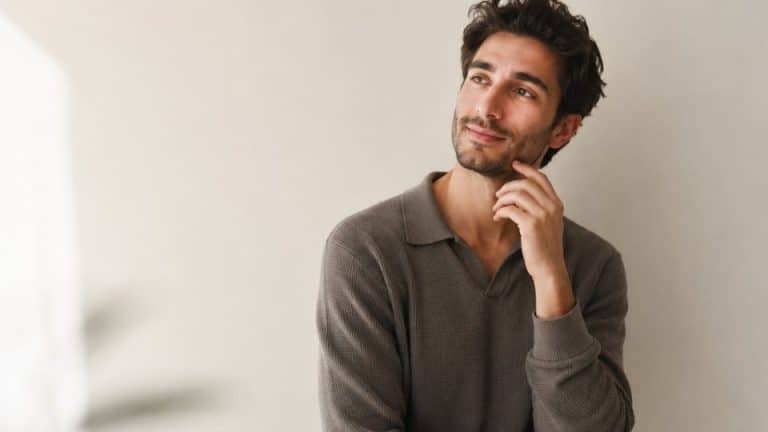 IOP vs Therapy hero image of a man considering the difference between the two options for treatment.