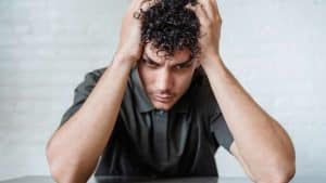 Dopamine Recovery Timeline hero image of a man holding his head.