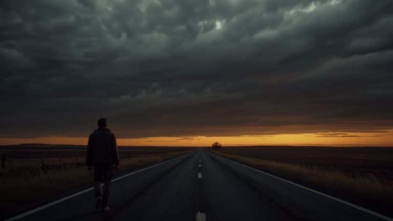 the stages of addiction hero image of a man walking on a road through a dark sky.